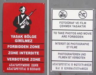 Signs on a metal gate in the capital city of Nicosia.